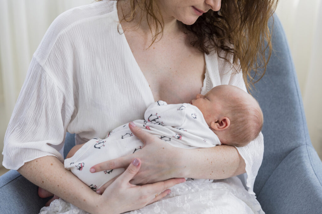 A mother breastfeeding her baby, symbolizing the possibility of nursing with breast implants. Dr Tracy Pfeifer, New York, Hamptons